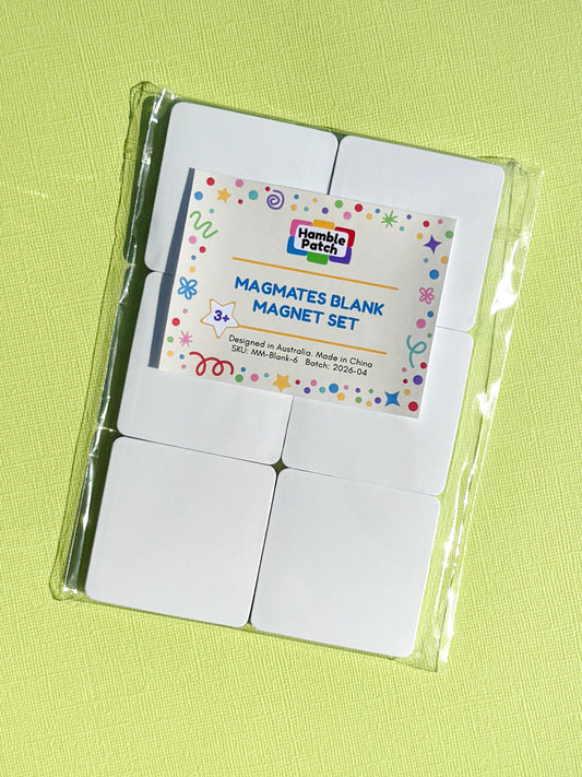 A packaged blank magnet set by Hamble Patch, containing six white square magnets in a clear plastic bag with a decorative paper label, placed on a light green textured background.