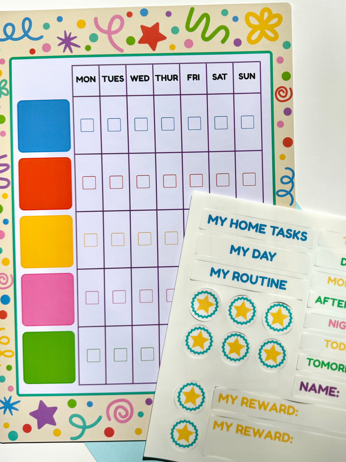 A colourful weekly planner magnetic board with a weekly schedule from Monday to Sunday, a column of bright colour blocks on the left, and two silicone sticker sheets featuring task labels and star-shaped stickers, arranged on a white background.